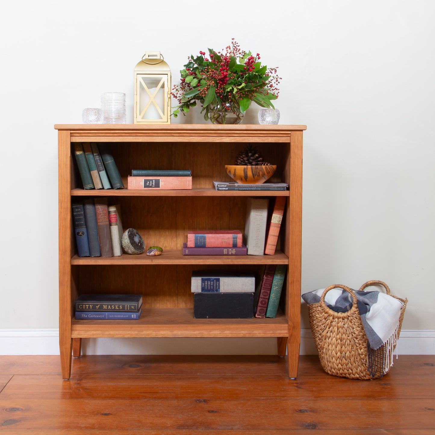 Vermont Shaker 37" Bookcase by Maple Corner Woodworks showcasing its elegant design with various items neatly stored on its shelves.