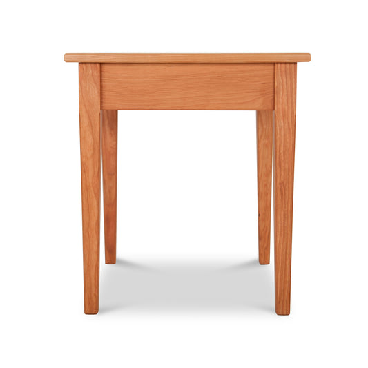 A Vermont Shaker End Table from Maple Corner Woodworks with a smooth surface and rounded edges, featuring visible wood grain, isolated against a white background.