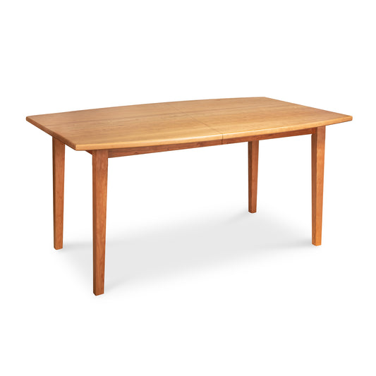 A Maple Corner Woodworks Vermont Shaker Boat Top Extension Dining Table, crafted from sustainably harvested wood, features a light finish and simple, straight legs on a white background.