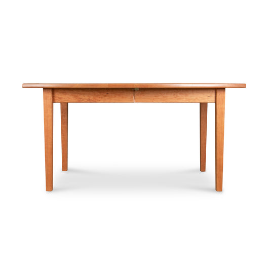 Solid wood Vermont Shaker Boat Top Extension Dining Table featuring tapered legs and a visible extension seam.