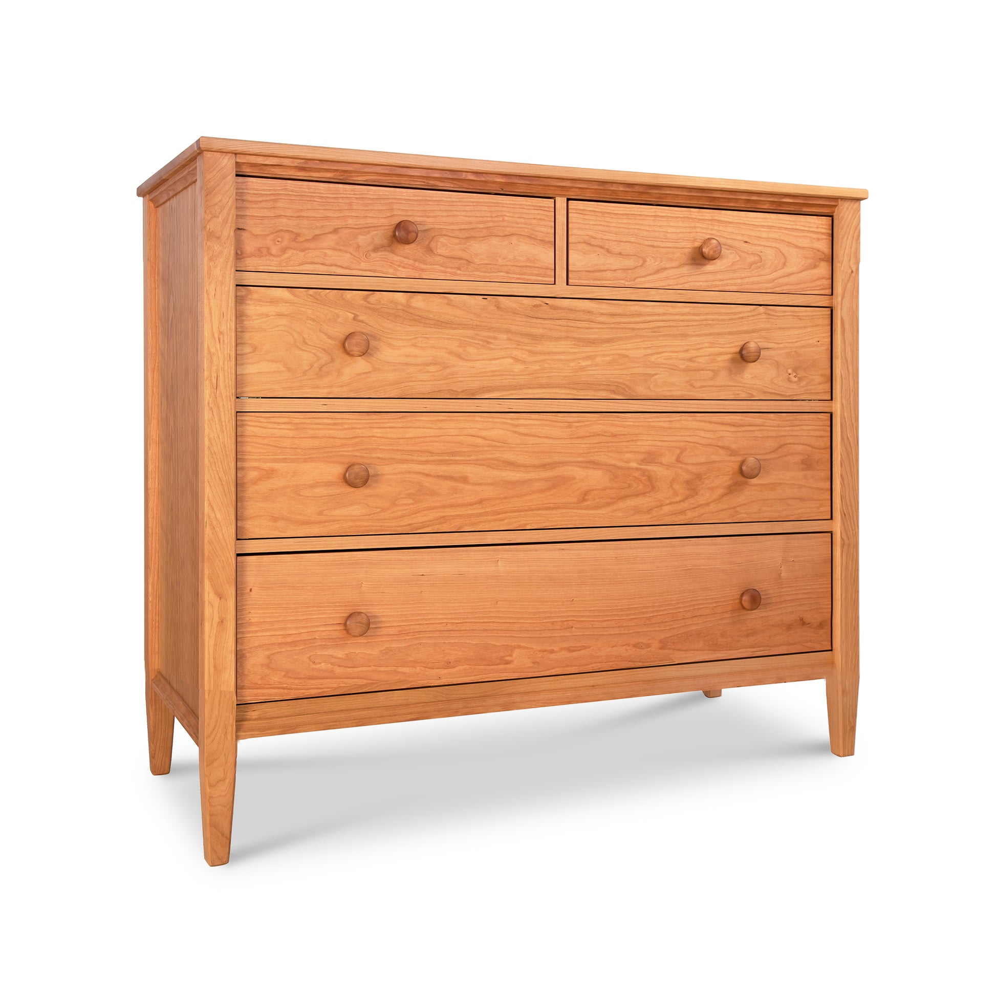 A Maple Corner Woodworks Vermont Shaker Extra Wide Chest with six drawers, featuring round knobs and a smooth finish, crafted from natural cherry hardwood, isolated on a white background.