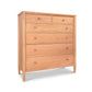 A Vermont Shaker Extra Wide Chest of drawers with five horizontal drawers, increasing in size from top to bottom, set against a white background by Maple Corner Woodworks.