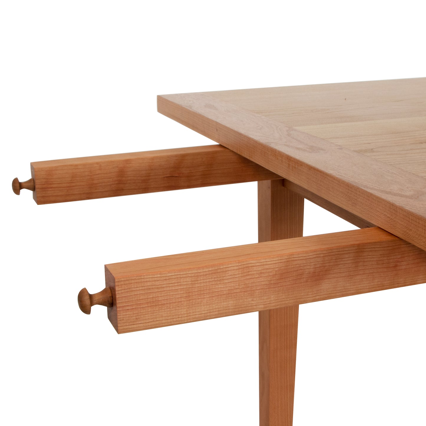 Close-up of a Maple Corner Woodworks Vermont Shaker Harvest Extension Dining Table, with extendable sections partially pulled out, showcasing the sustainably harvested woods.