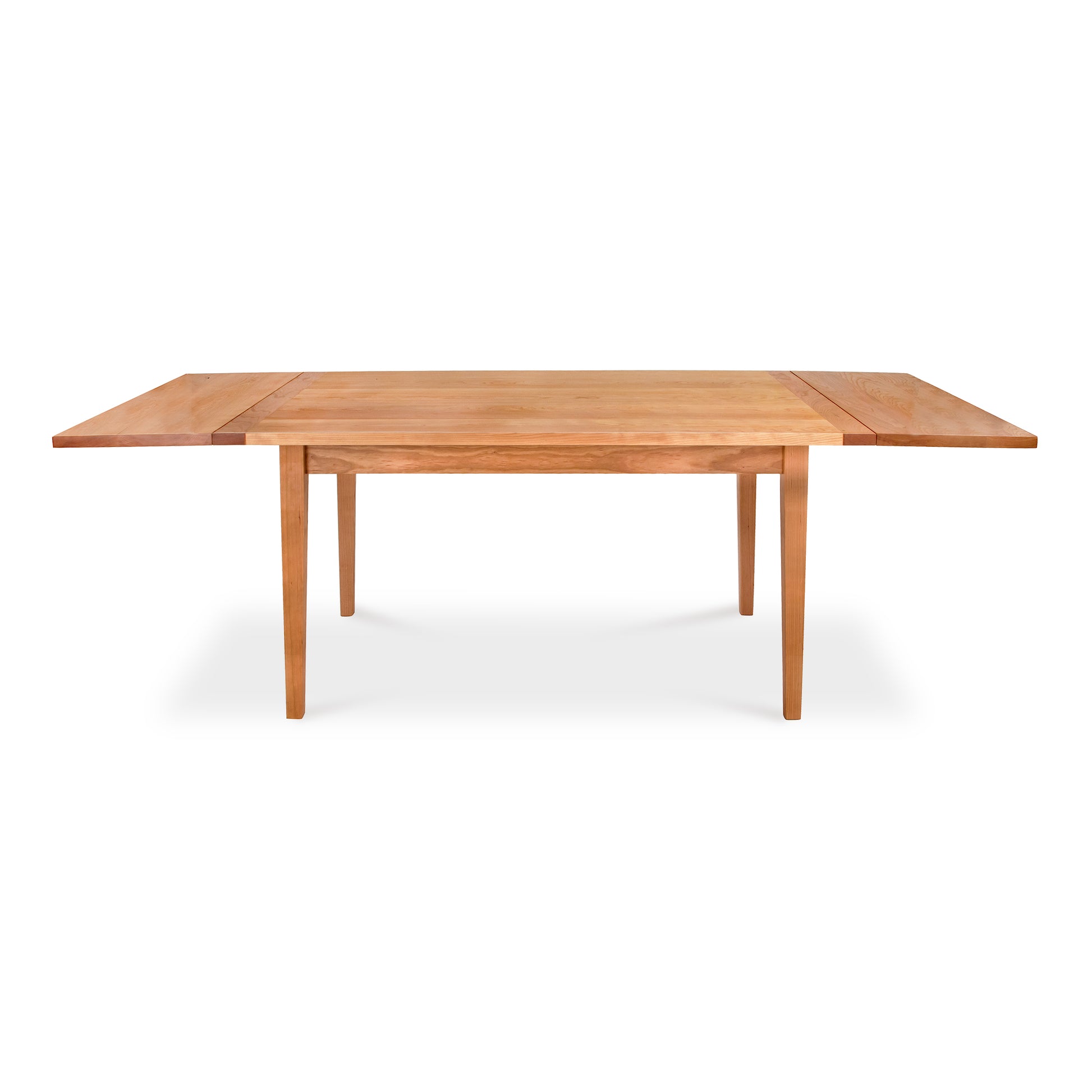 A Vermont Shaker Harvest Extension Dining Table, crafted from sustainably harvested woods by Maple Corner Woodworks, with two extendable leaves, shown extended, on a plain white background.