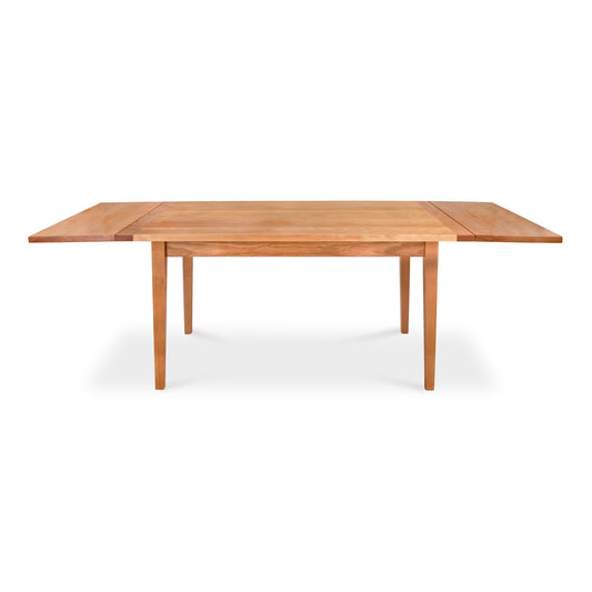 Vermont Shaker Harvest Extension Dining Table by Maple Corner Woodworks, handcrafted from solid wood with elegant tapered legs, shown as a display model.