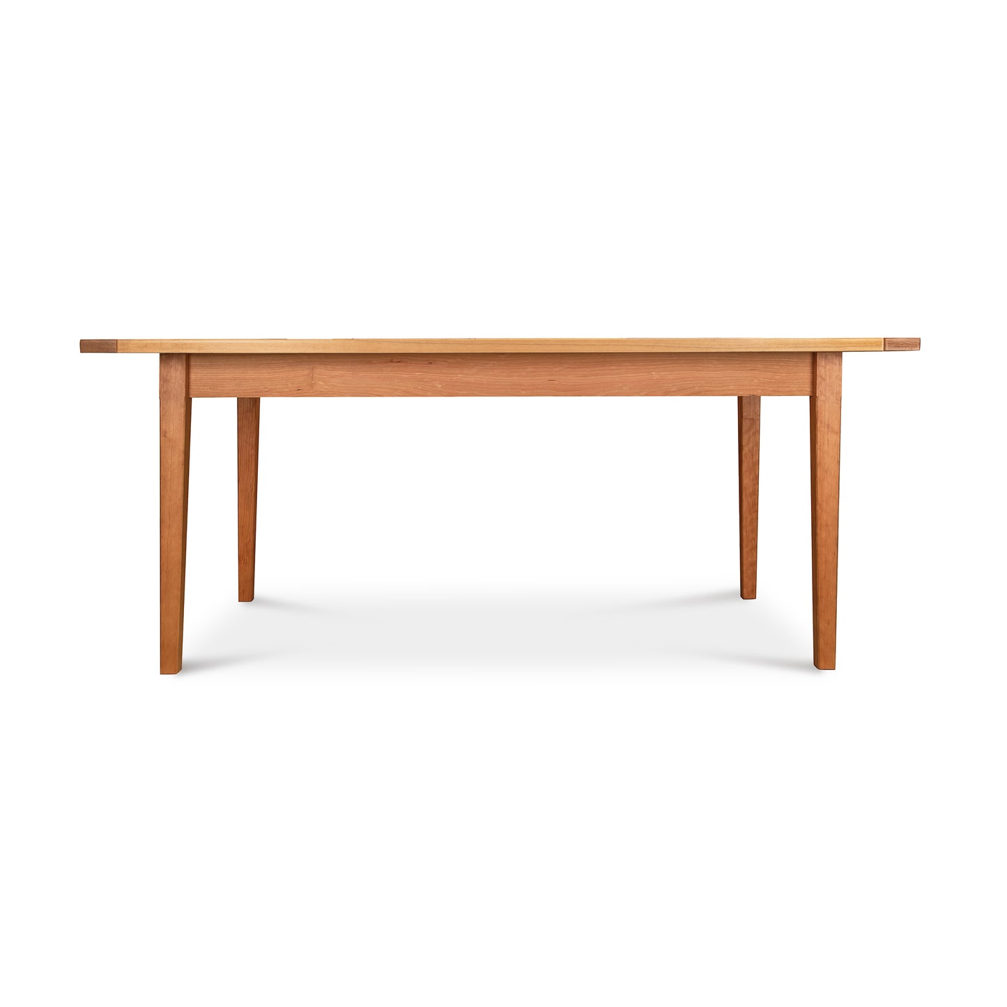 Vermont Shaker Solid Top Harvest Table by Maple Corner Woodworks in natural cherry wood, featuring a classic rectangular design and sturdy four-legged support.