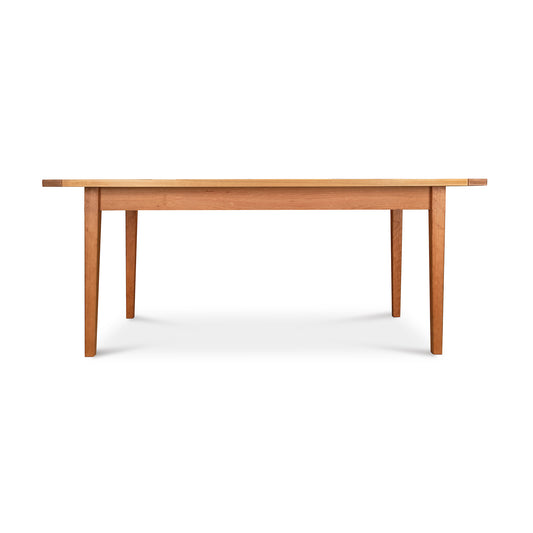 Vermont Shaker Solid Top Harvest Table by Maple Corner Woodworks in natural cherry wood, featuring a classic rectangular design and sturdy four-legged support.