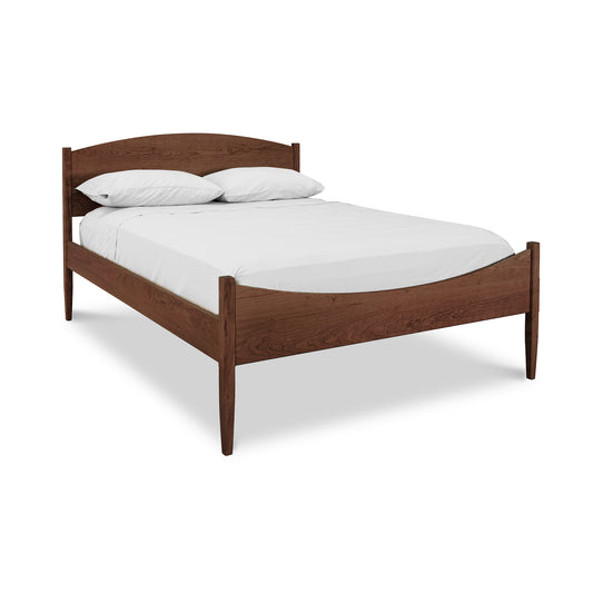 Vermont Shaker Moon Bed by Maple Corner Woodworks showcasing its elegant wooden frame and distinctive headboard.