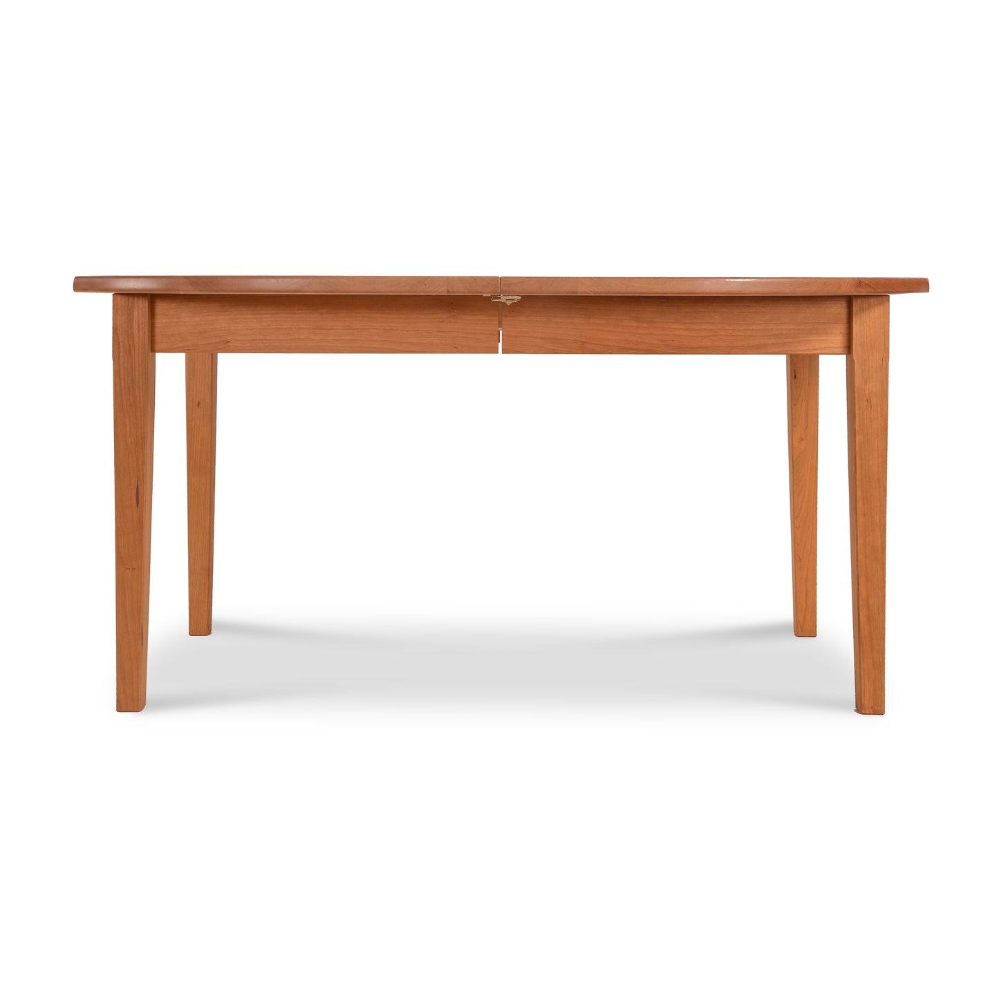 A Maple Corner Woodworks Vermont Shaker Oval Extension Dining Table isolated on a white background, featuring a simple, sturdy design with four straight legs and a rectangular top.