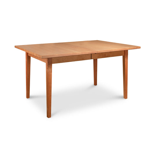 Vermont Shaker Rectangular Extension Dining Table from Maple Corner Woodworks, sustainably harvested wood, isolated on a white background.