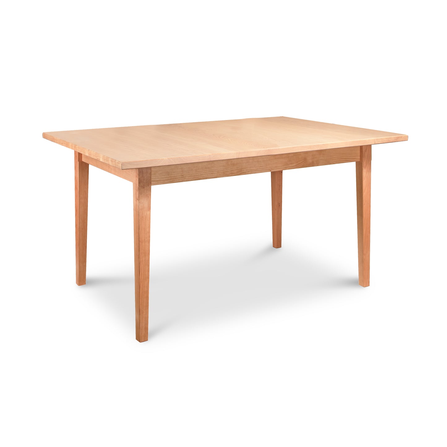 A simple Vermont Shaker Rectangular Solid Top Dining Table with a rectangular top and four legs, isolated on a white background by Maple Corner Woodworks.