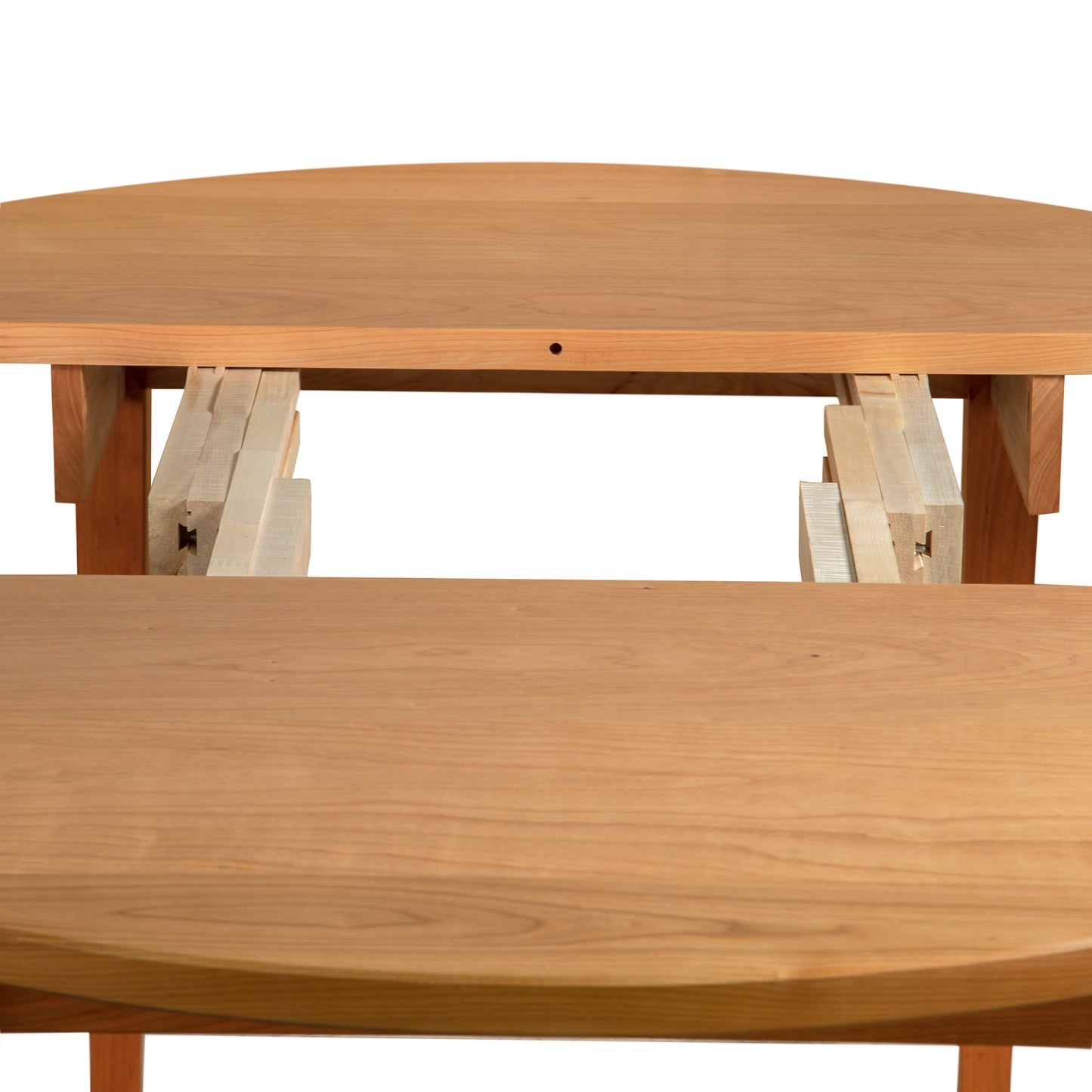 Maple Corner Woodworks Vermont Shaker Round Extension Table showcasing its visible extension mechanism and stunning wood grain pattern, emphasizing its eco-friendly craftsmanship.