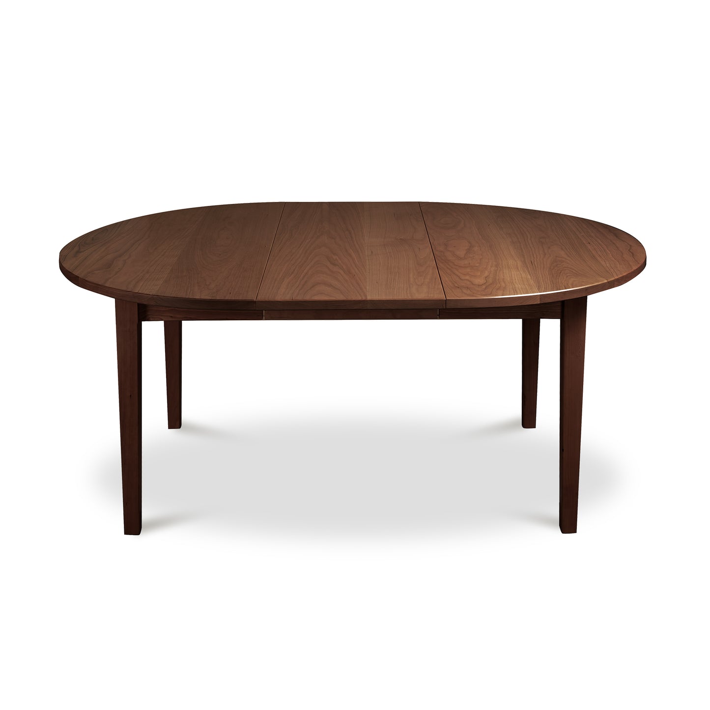 Round wooden Vermont Shaker Extension Table by Maple Corner Woodworks with four sturdy legs and medium dark finish, showcasing eco-friendly craftsmanship.