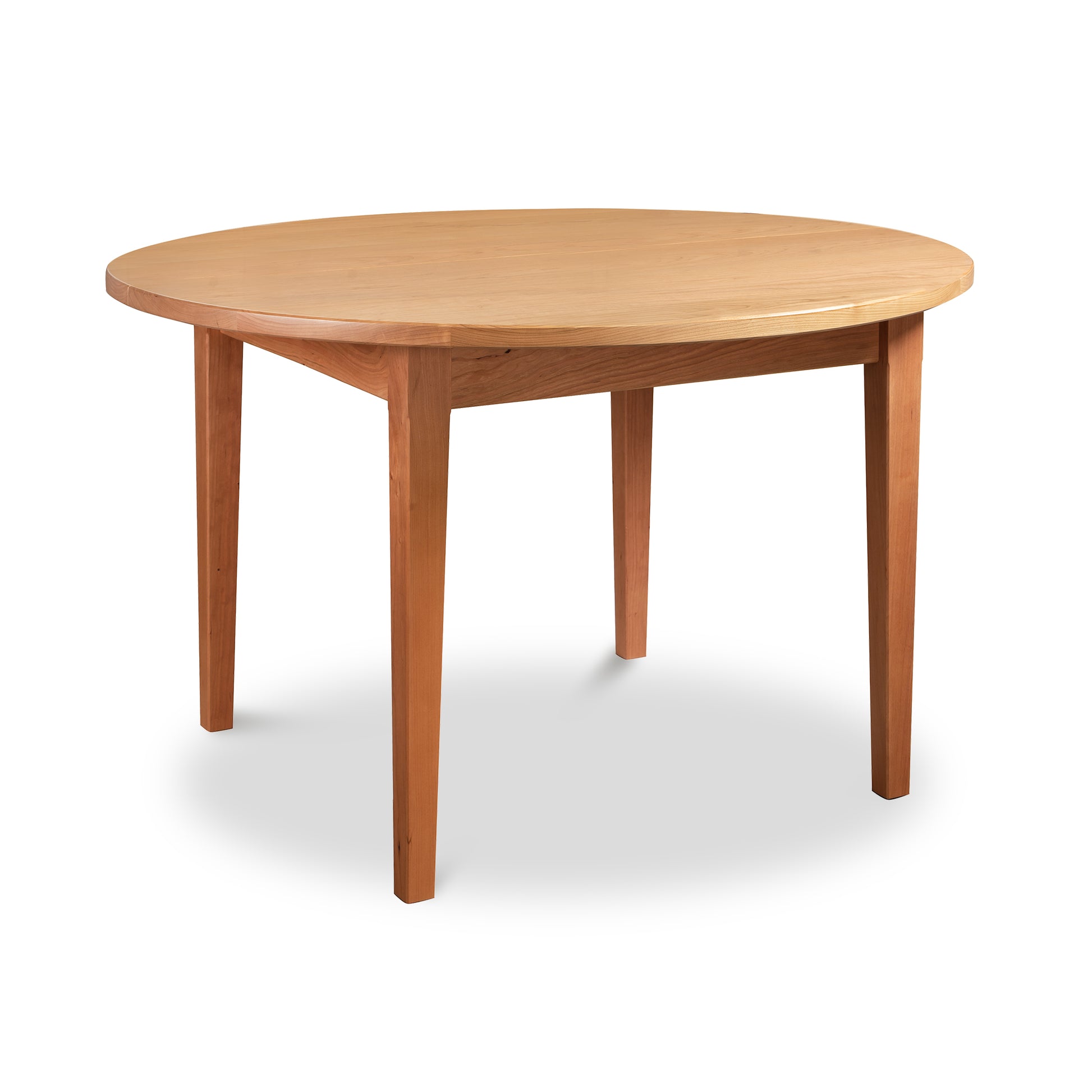 Vermont Shaker Round Solid Top Table by Maple Corner Woodworks, showcasing its smooth wooden round top and four straight legs.