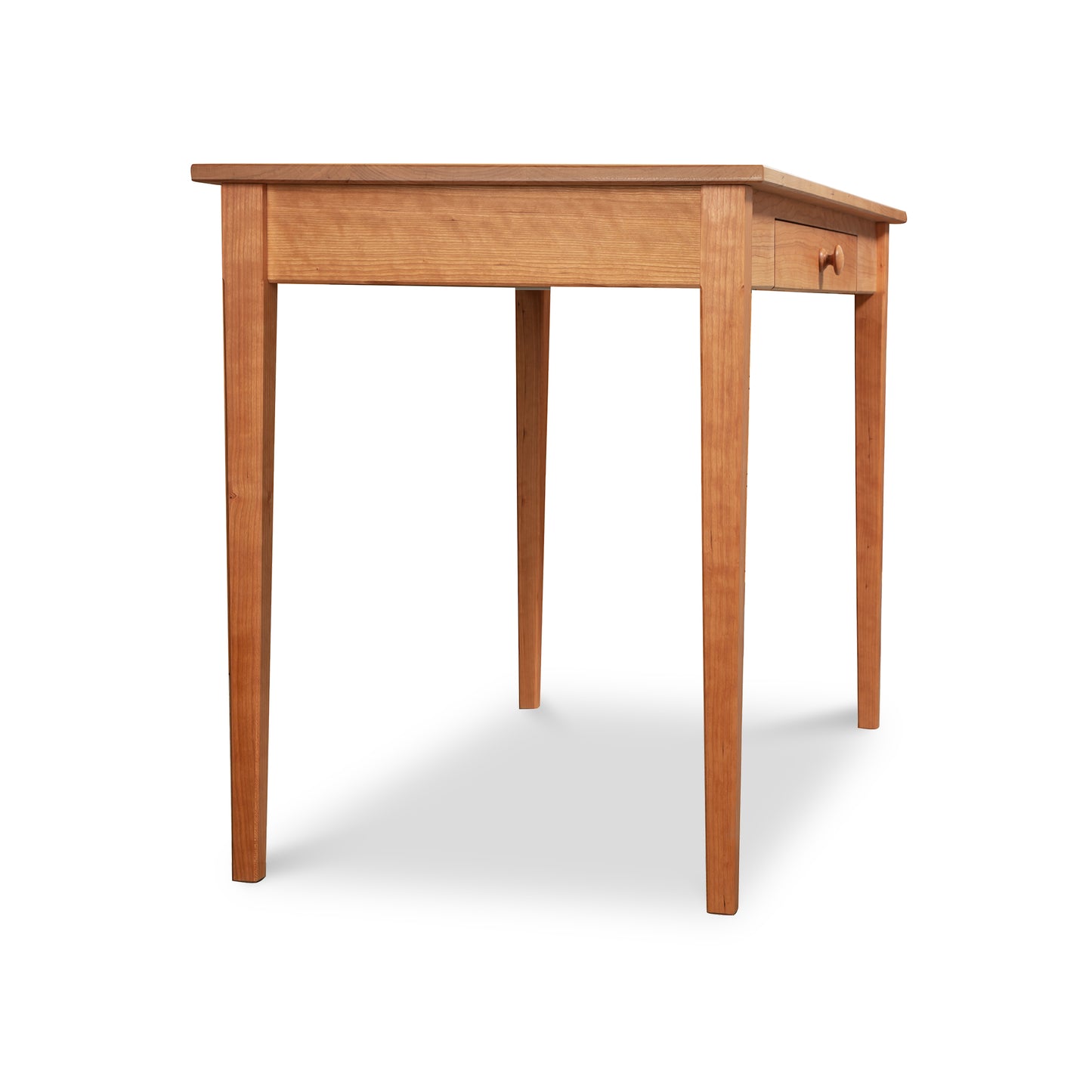 An eco-friendly Vermont Shaker Writing Desk with a single drawer, standing on four straight legs, isolated on a white background by Maple Corner Woodworks.