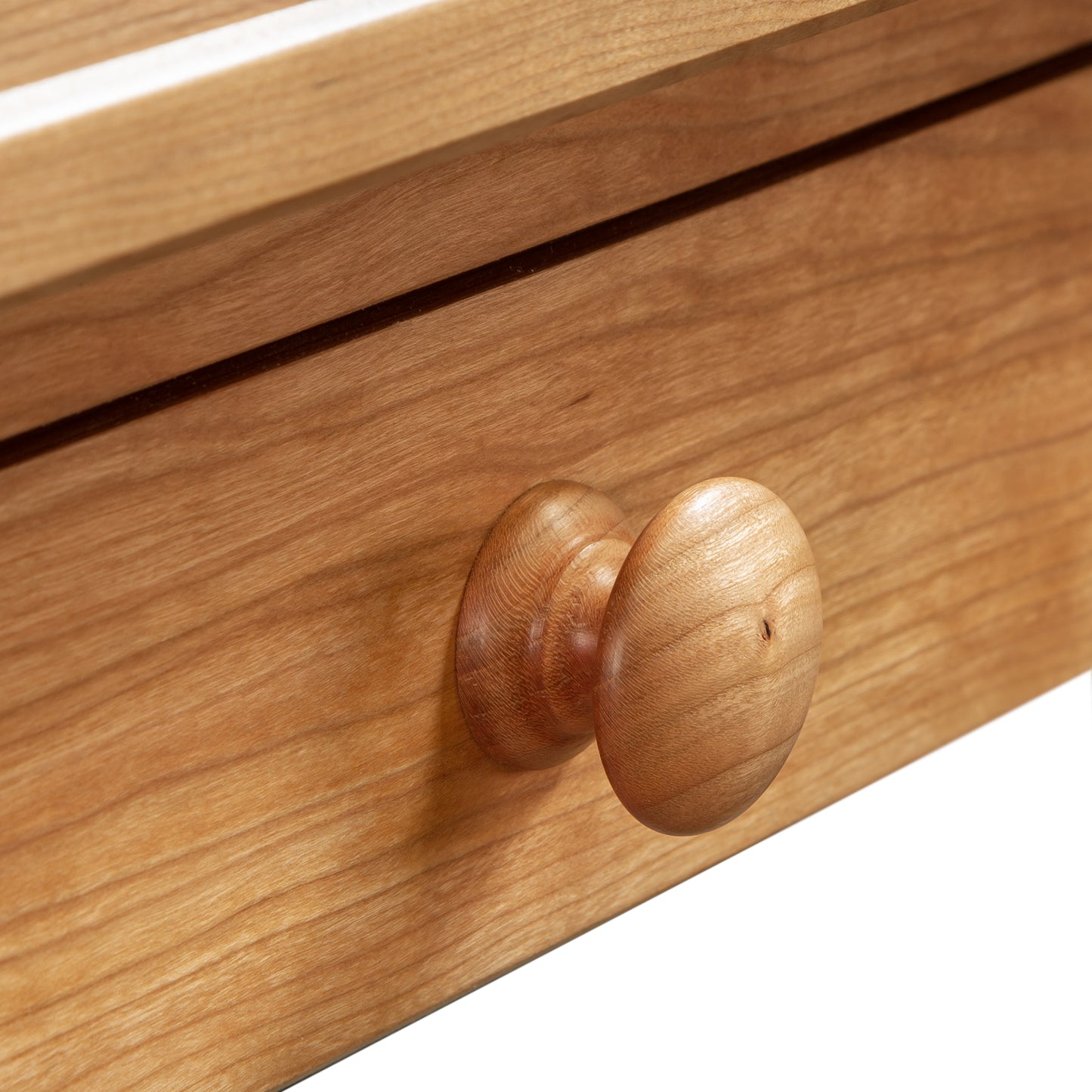 Detail view of a solid maple drawer on the Vermont Shaker Writing Desk by Maple Corner Woodworks, highlighting fine grain and craftsmanship.