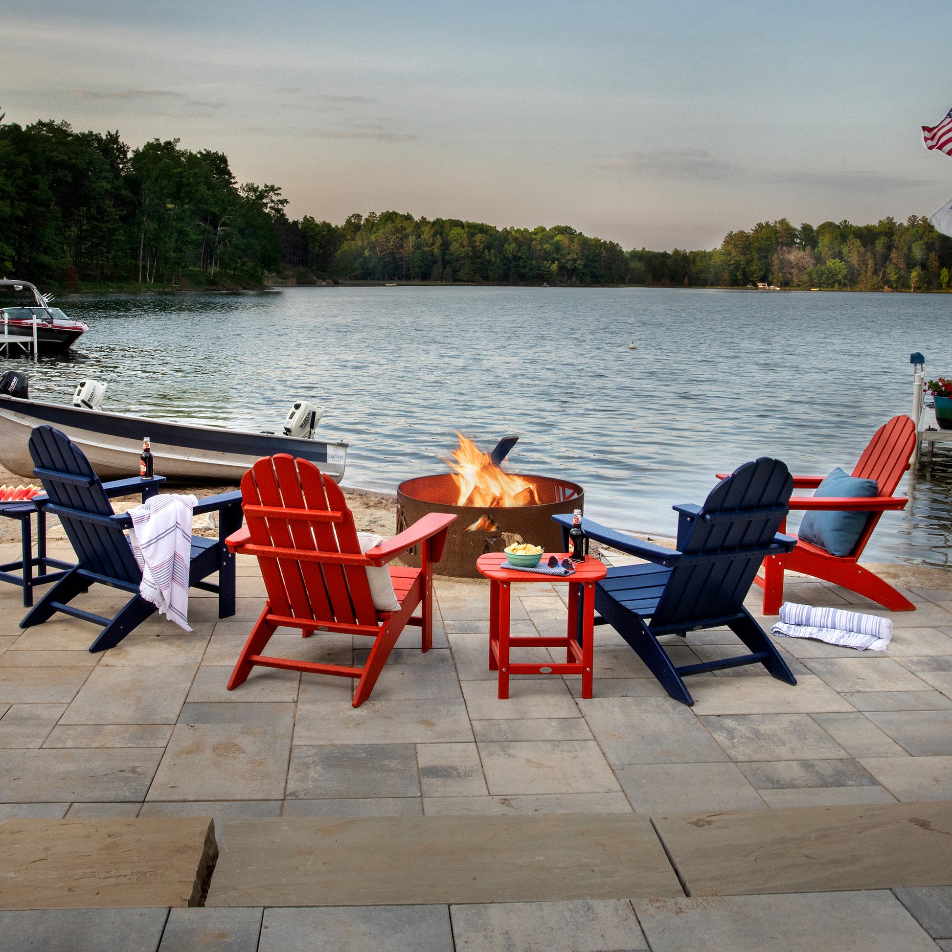Red and blue POLYWOOD Vineyard Adirondack Chairs surrounding a fire pit.