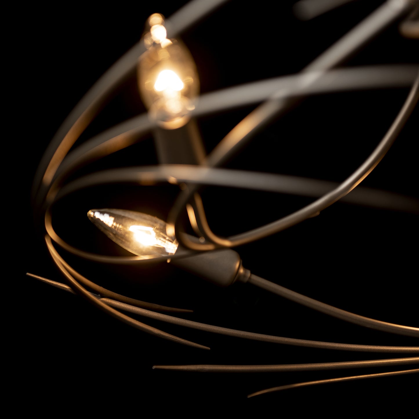 A close up of the Hubbardton Forge Wisp 6-Light Chandelier, exuding an elegant silhouette.