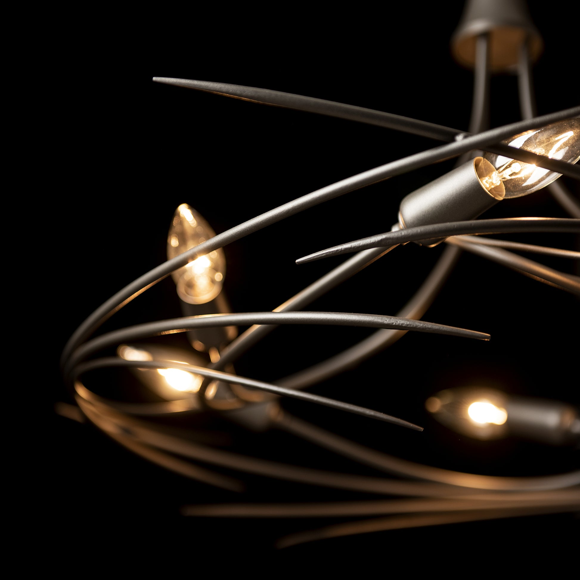 The Hubbardton Forge Wisp 6-Light Chandelier showcases an elegant silhouette with its fine tailoring, featuring stunning lights that beautifully illuminate any space.