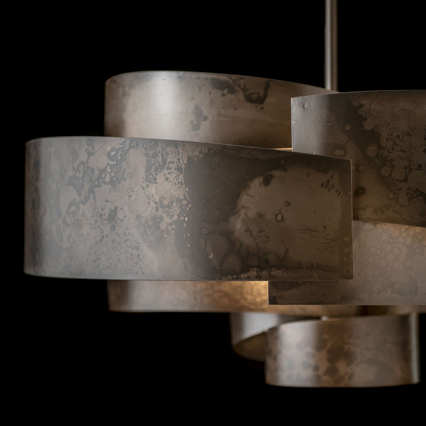 Zen Pendant by Hubbardton Forge featuring wide overlapping bands and a handcrafted marbled finish, highlighting its unique design and artisan craftsmanship.