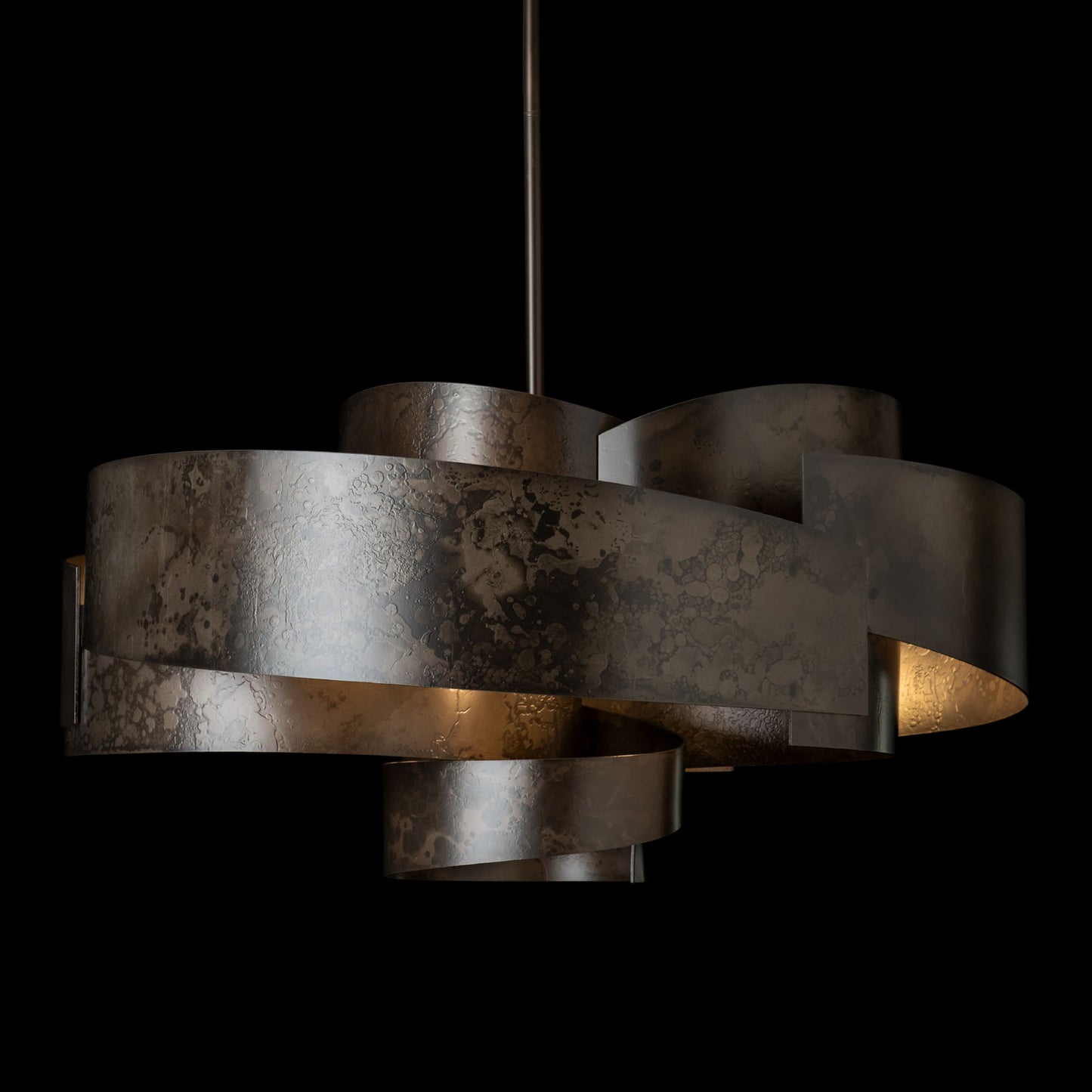 Zen Pendant light by Hubbardton Forge with wide, handcrafted metallic bands forming a modern spiral design.