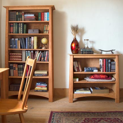 Two wooden bookcases in a room.