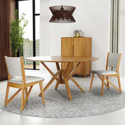 A dining room with a round table and chairs.