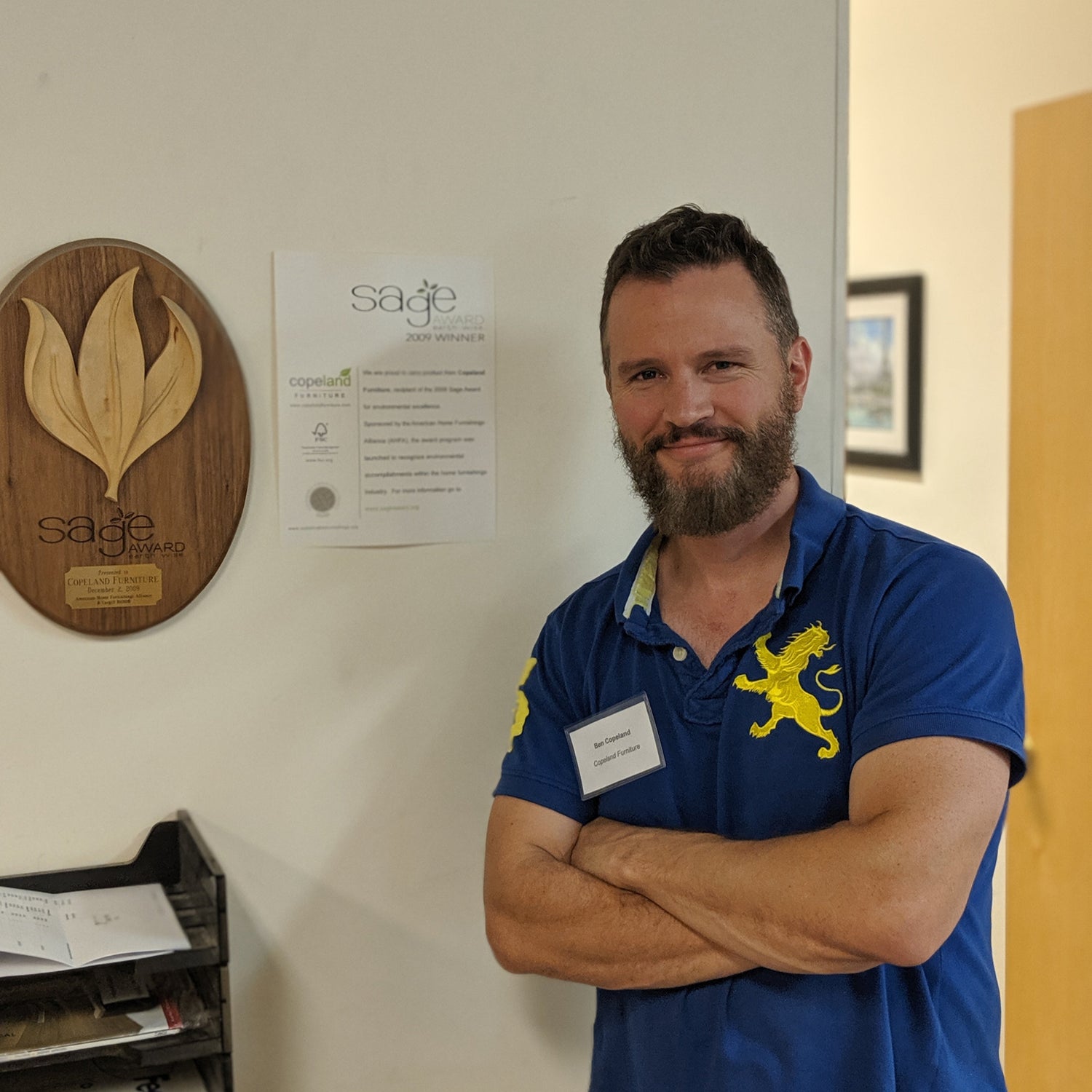 Ben Copeland stands proudly next to Sage Award for Innovation in Sustainable Practices
