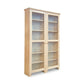 A large Lyndon Furniture Custom Shaker Wide Bookcase with Full Glass Doors crafted from sustainably harvested hardwoods, featuring several shelves enclosed by glass doors, set against a plain white background.