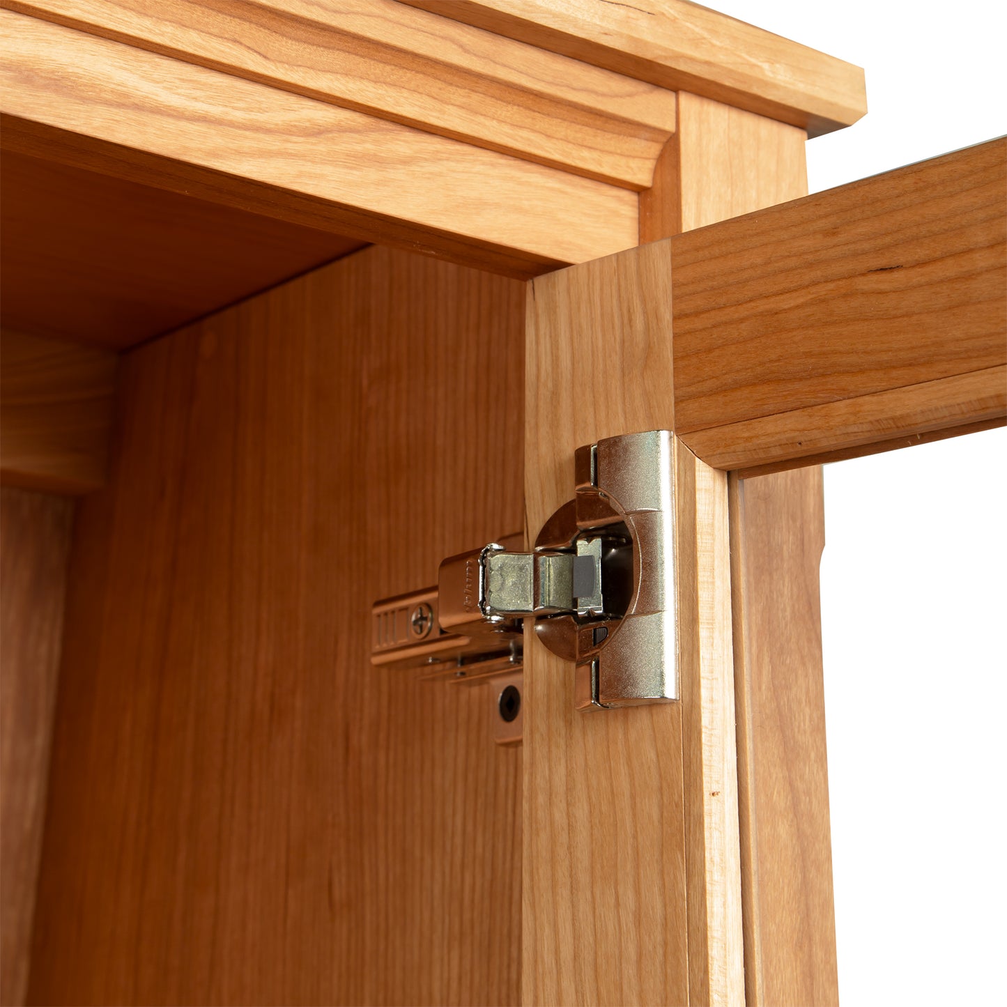 Detail of the handcrafted wood and glass doors on the Custom Vermont Shaker Bookcase by Maple Corner Woodworks, highlighting fine furniture craftsmanship.