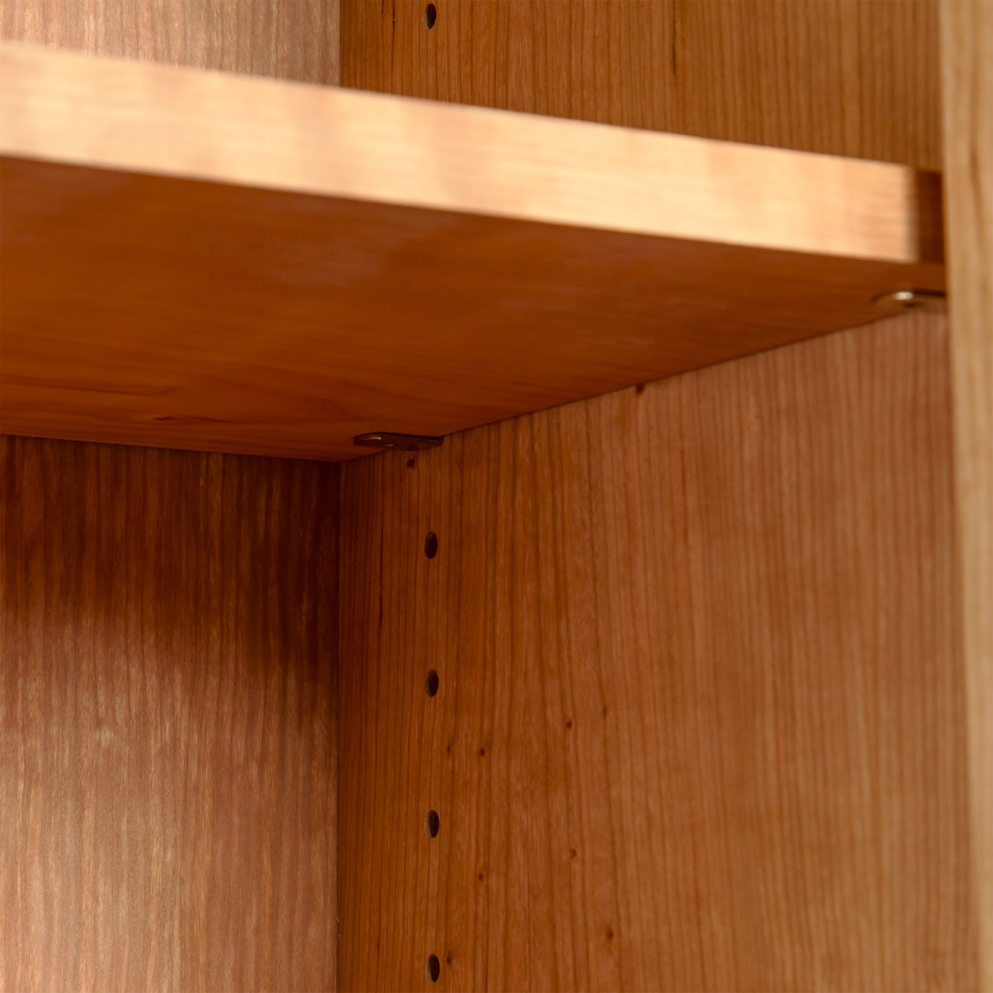 Maple Corner Woodworks Custom Vermont Shaker Bookcase with Glass Doors, featuring adjustable shelves and support holes in the solid hardwood frame.