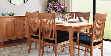 Solid wood dining table with six matching chairs, featuring elegant craftsmanship.