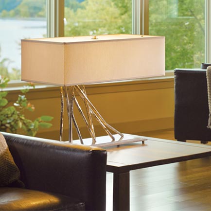 A living room with a couch and a lamp.