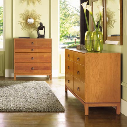 A room with a dresser and a rug.