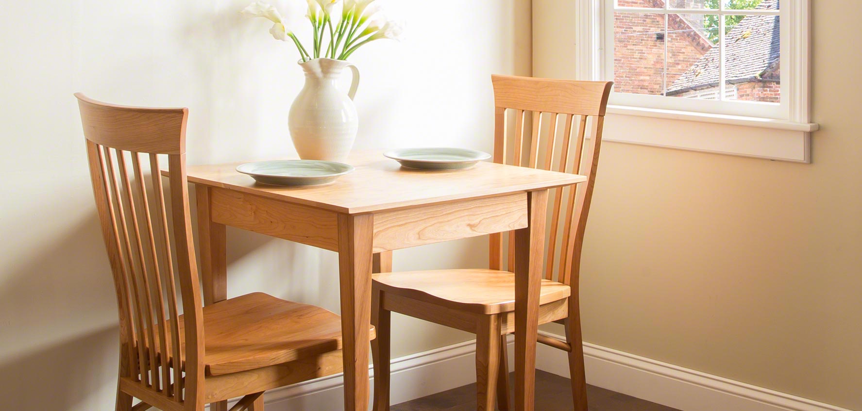 A small table and chairs in a small room.