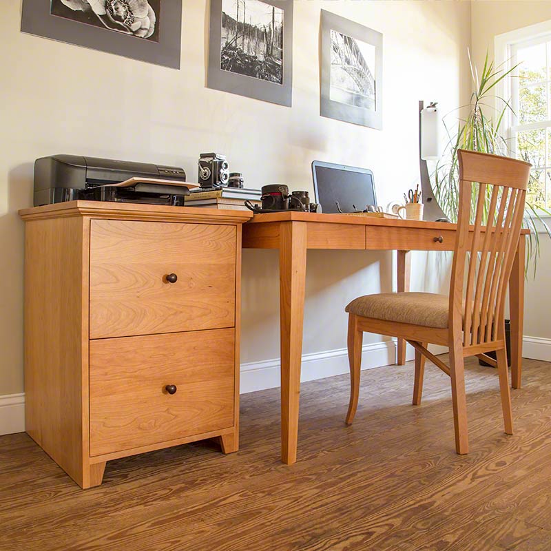 A desk and chair in a home office.
