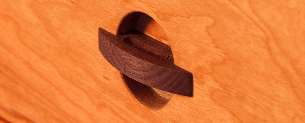 A close up of a wooden door with a hole in it.