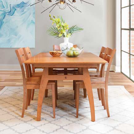 A dining room with a wooden table and chairs.