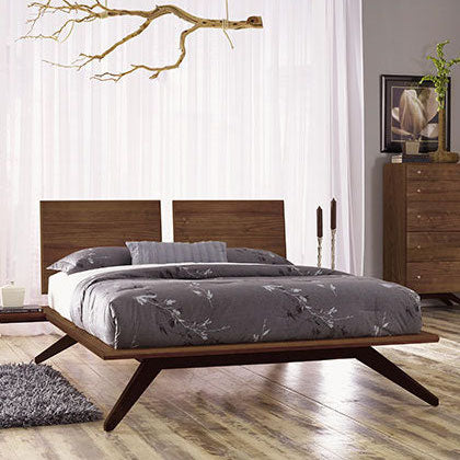 A modern bedroom with a wooden bed and dresser.