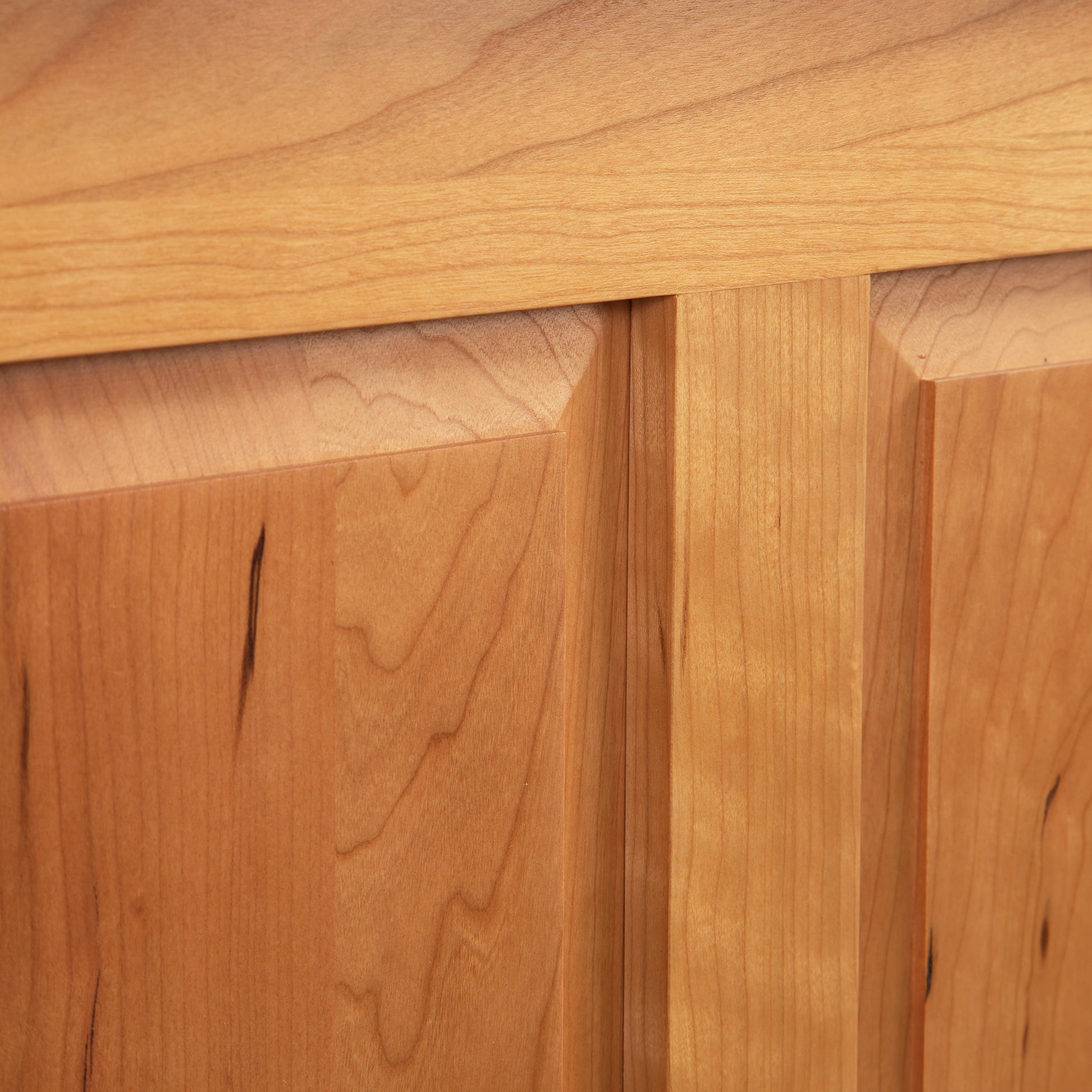 A close up of a wooden cabinet door.