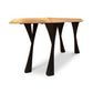 A table with black legs and a wooden top.