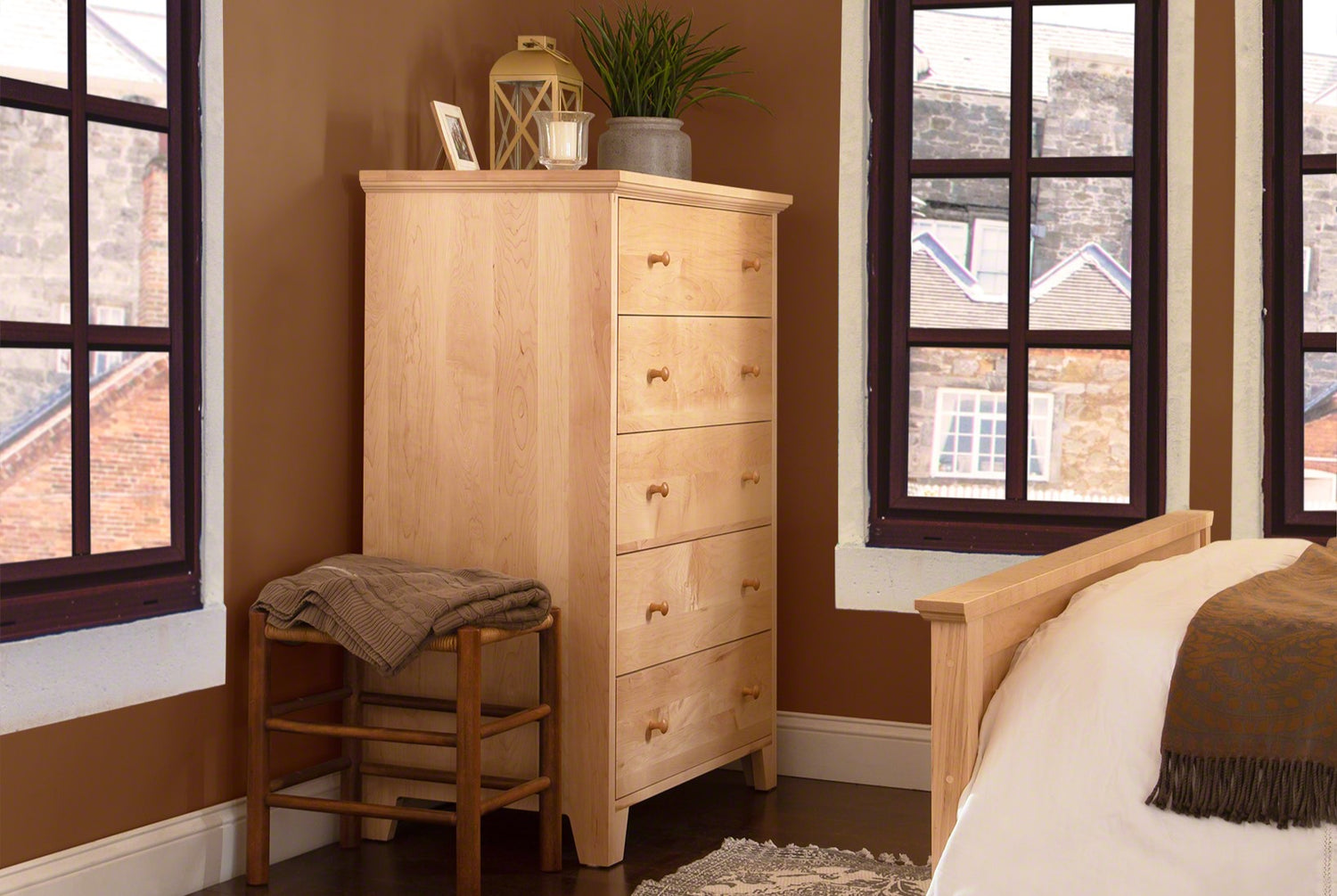 A wooden chest of drawers in a bedroom.