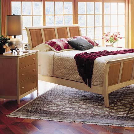 A bedroom with a bed and dresser.