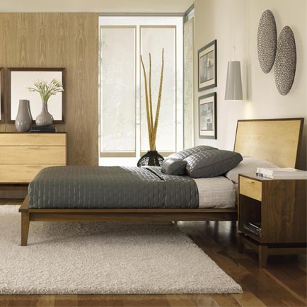 A bedroom with a bed, dresser, and mirror.