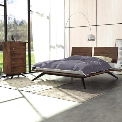 A modern bedroom with a wooden bed and dresser.