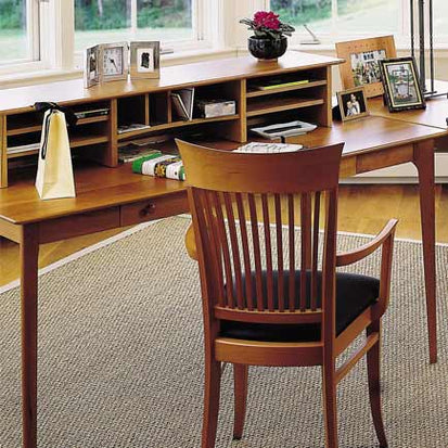 A home office with a desk and chair.
