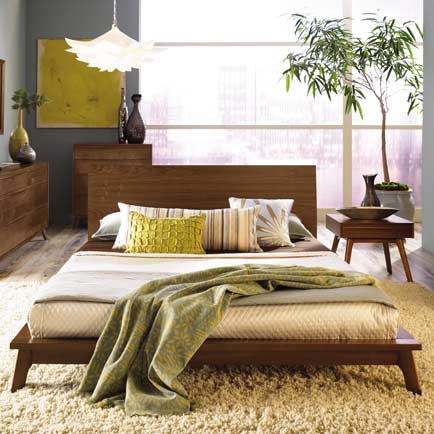 A bedroom with a bed and dresser.