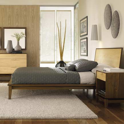 A bedroom with a bed, dresser and mirror.