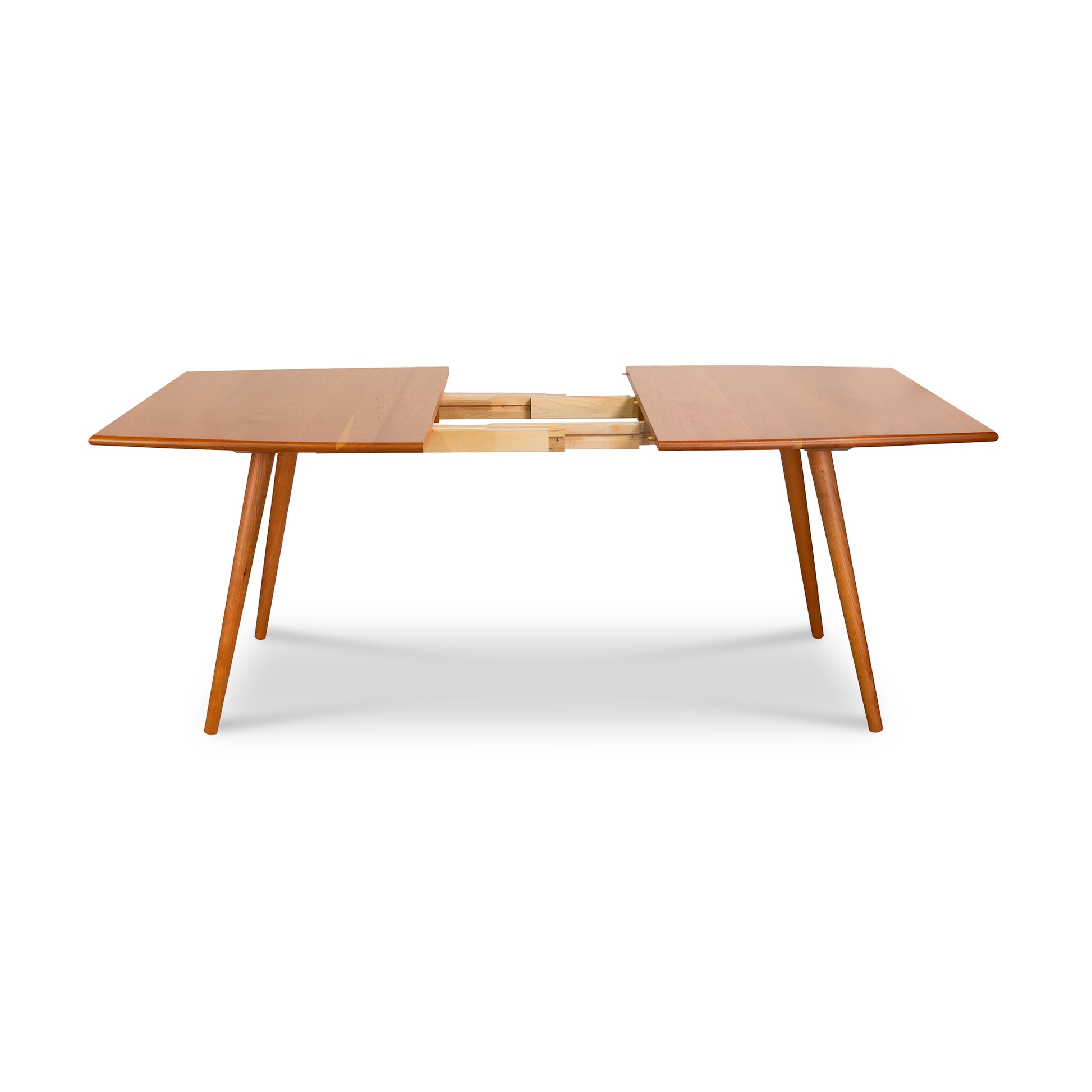 The Lyndon Furniture Addison Boat Top Extension Dining Table is a stunning example of a mid-century modern dining room table crafted from natural cherry wood. With its sleek design and unique two-leg structure, this wooden dining table.