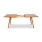 A mid-century modern Addison Boat Top Extension Dining Table - Floor Model from Lyndon Furniture with two legs.